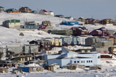 The Unikkaarvik Visitors Center and houses up the hill seen from the shore. Iqaluit. Nunavut. Canada. 2008