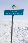 The Road to Nowhere street sign in Iqaluit with the fish logo and syllabics. Nunavut. Canada. 2008