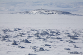Sea ice at low tide that is sitting on boulders on the beach that fracture and break the ice. Iqaluit. Canadian Arctic. Nunavut. 2008