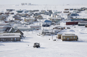 The sewage truck returning to the Inuit village of Igloolik seen from Cemetery Hill. Nunavut. Canada. 2008