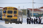 Inuit schoolchildren in Igloolik queue to get on the school bus. Nunavut. Canada. 2008