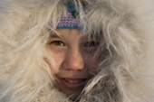 Portrait of inuit girl Kaya Natar wearing a fur trimmed hood. Igloolik. Nunavut. Canada. 2008