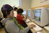 Inuit pupil Jeremy Tulugarjuak works at his computer studies in school. Igloolik. Nunavut, Canada. Model released. 2008