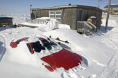 Cars buried by the winter's snow outside a home in Iqaluit. Nunavut, Canada. 2008