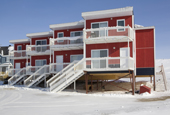 Modern Arctic homes built on piles driven into the permafrost at Iqaluit. Nunavut, Canada. 2008