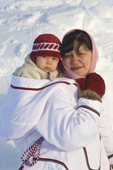 Lisa Ann Airut, an Inuit woman from Igloolik, carrying her baby in a traditional Baffin Island Parka. Igloolik, Nunavut, Canada. 2008