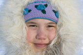 Kaja Natar, an Inuit girl from Igloolik wearing a parka with a fox fur hood. Nunavut, Canada. 2008
