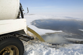 Raw sewage pours from a tanker into a sewage lagoon on Igloolik Island. Nunavut, Canada. 2008