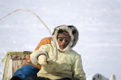 Jaipiti Palluq, an Inuit hunter, uses his whip while driving his dog team near Igloolik. Nunavut, Canada. 2008