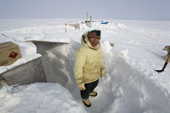 Jaipiti Palluq, an Inuit hunter, stands on the snow steps leading from the hut at his outpost camp on Igloolik Island. Nunavut, Canada. 2008