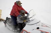 Noah Metuq, an Inuit hunter from Pangnirtung, travelling by snowmobile with his son Aidan. Nunavut, Canada. 2008