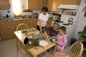 The Metuq family preparing a chicken lunch at their home in the Inuit community of Pangnirtung. Nunavut, Canada. 2008