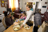 The Metuq family having chicken for lunch at their home in the Inuit community of Pangnirtung. Nunavut, Canada. 2008
