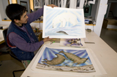 Inuit artist, Jolly Attoguquk displays some of his prints at the Uqqurmiut Centre for Arts and Crafts in Pangnirtung. Nunavut, Canada. 2008