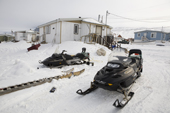 The Metuq's family home with snowmobiles, sleds & other hunting equipment outside. Pangnirtung, Nunavut, Canada. 2008