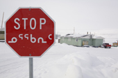 A stop sign in English & Inuktitut at a road junction in the Inuit community of Pangnirtung. Nunavut, Canada. 2008