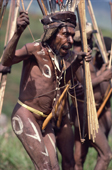 Yali Warrior fully decorated holds poison arrows. Seng Valley, Irian Jaya, Indonesia. 1990