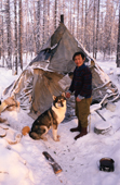 Victor Ivanovich, An Evenki man, with his dog at a reindeer herders' winter camp. Evenkiya, Central Siberia, Russia. 1997