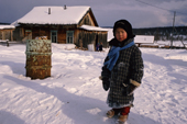 An Evenki boy outside his home in Surinda. Evenkiya, Central Siberia, Russia. 1997