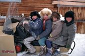 Evenki children playing on a Russian snowmobile. Surinda, Evenkiya, Siberia, Russia. 1997