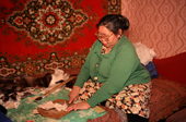 An Evenki woman making a pair of reindeer skin boots. Surinda, Evenkiya, Siberia, Russia. 1997