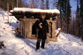 A Russian hunter outside his wooden hut in the forest near Tura. Evenkiya, Central Siberia, Russia. 1997