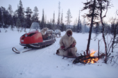 Olga Kirillova, a Sami woman from Lovozero, lights a fire during a break in a snowmobile journey. Murmansk, NW Russia. 2005