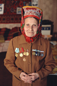 Maria Zakharova, an 82 year old Sami woman, wearing a jacket with her Soviet medals in her apartment in Lovozero. Murmansk, Kola Peninsula, NW Russia. 2005