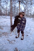 Misha Elrika, an Even boy, plays with a dog at a reindeer herders' camp in Northern Evensk. Magadan Region, Russia. 2006