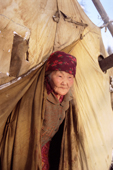 Daria Elrika, an elderly Even woman, looks out of her tent at a reindeer herders' winter camp in N. Evensk, Magadan region, E. Siberia, Russia. 2006