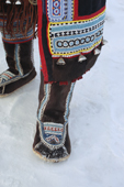 An Even woman wearing a pair of traditional reindeer skin boots decorated with bead work. Evensk, Magadan, E. Siberia. 2006
