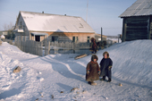 Nenets children warmly dressed, playing outside in the village of Syunai-Sale, Yamal, Siberia, Russia.