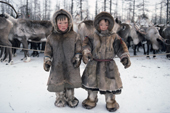 Two young Nenets boys in winter dress at a reindeer herders' camp in the Yamal. Western Siberia, Russia