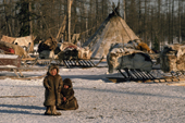 Nenets children playing outside at a reindeer herders winter camp. Yamal, Siberia, Russia.