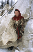 Ludmilla Serotetto, a Nenets woman, emerges from reindeer skin tent. Yamal, Siberia, Russia