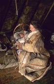 Inside a reindeer skin tent a Anastasia Pulka, a Nenets woman, comforts her baby daughter, Elvira. Yamal, Siberia, Russia