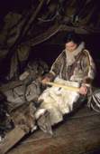 Nina Khudi, a Nenets woman scrapes a reineer skin to soften it. It will be used to make traditional skin clothes. Yamal, Siberia, Russia