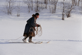 Andre Khudi, a young Nenets man, on skis with lasso ready, stalking a reindeer he is attempting to lasso. Yamal, Siberia.