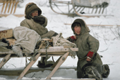 Two Nenets boys,Bora Serotetto (left) and Vanya Vilik, by a sled at a reindeer herders' winter camp. Yamal, Western Siberia, Russia.