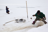 Pyotr & Edik Serotetto, young Nenets men, checking their fishing net set under the sea ice to catch Muksun. Seyakha, Yamal Peninsula, Western Siberia