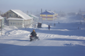 Snowmobile on the main street in the Nenets village of Seyakha during a storm. Yamal Peninsula, Western Siberia, Russia