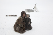 Sveta, a Nenets woman, with her son Timophey, at their winter camp on the tundra near Tambey. Yamal Peninsula, Western Siberia, Russia
