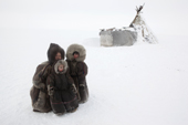 Sveta, a Nenets woman, with her son Timophey & daughter Yuia, at their winter camp on the tundra near Tambey. Yamal Peninsula, Western Siberia, Russia