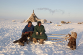 At his winter camp, Jakov Vanuito, a Nenets reindeer herder, relaxes with his friend Vadim (left) and his daughter Nenya. Tambey. Yamal Peninsula, Western Siberia, Russia