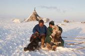 At his winter camp, Jakov Vanuito, a Nenets reindeer herder, relaxes with his friend Vadim (left) and his daughter Nenya. Tambey. Yamal Peninsula, Western Siberia, Russia