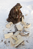 Nyaka, a 76 year old Nenets woman, chopping firewood at her family's winter camp near Tambey. Yamal Peninsula, Western Siberia, Russia