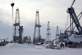 Cranes and drilling derricks near Sabetta in the South Tambey gas field. Yamal Peninsula, Western Siberia, Russia