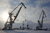 Cranes and drilling derricks at the port in Sabetta in the South Tambey gas field. Yamal Peninsula, Western Siberia, Russia