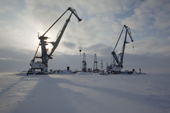 Cranes and drilling derricks at the port in Sabetta in the South Tambey gas field. Yamal Peninsula, Western Siberia, Russia