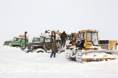 A bulldozer & trucks covered in snow after a storm at an exploratory gas drilling site in the South Tambey gas field. Yamal Peninsula, Western Siberia, Russia